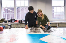 Two students looking at prints.