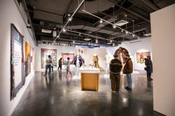 people gather in a spacious gallery for The Black Biennial