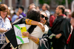 graduating students hug outside of the First Baptist Church, 2023