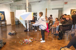 first-year student Emily Kwak takes a swing at her pinata during spring 2023 crits