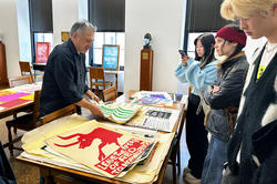 Students in Rene Payne's Be the Change Graphic Design course visit special collections to learn about RISD's archival history