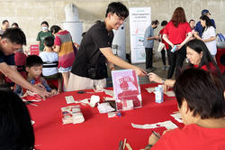 Joel Yong passes out information at a RED event