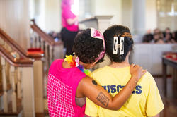 Orientation leaders hug during President's Welcome ceremony