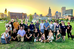 Group photo in front of the Providence City skyline at sunset