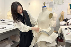 Sophomore Jaclyn Zhang sews a garment on a dress form