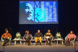 panelists on stage with an image of King behind them