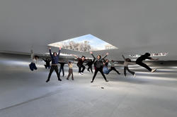 students on a trip to Japan celebrate the contemporary architecture with a big jump