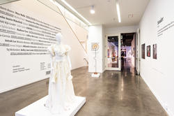 inside the Gelman Gallery with view of off-white cotton dress