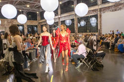 models and designers walk the runway together at the end of the show