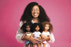 Yelitsa Jean-Charles poses with three of her Curl Friends dolls