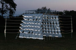 an architectural installation at Tillinghast glows in the twilit evening