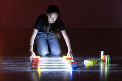 a student uses colorful lights in final performance piece