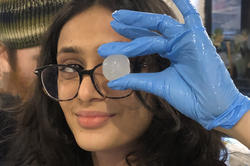 a student holds up a bioplastic bead