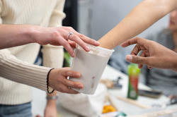 hands reaching out to test consistency of mold