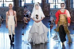 five models walk a fashion-show runway wearing designs by R I S D students