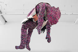 a colorful figure made of textiles suspended from the ceiling