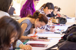 students working at a long table together