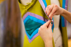 Closeup of hands sewing fabric in Apparel Design studio