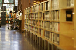 2 students working at computers in library