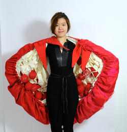Student wearing a red multi-fabric cape
