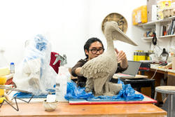 A Ceramics student working on a Pelican sculpture
