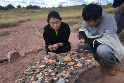 Students examining stones outside.