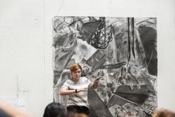 First-year presenting a large abstract charcoal drawing