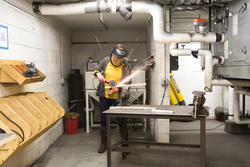 Sparks flying as a Furniture Design student works on a project