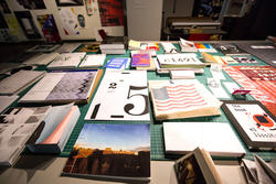 a table filled with books and zines created by Graphic Design students