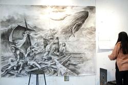 Large charcoal drawing of people on a raft in choppy waves with a whale