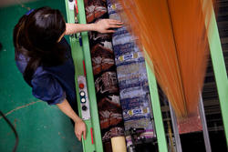 Student using jacquard loom.