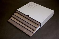 A set of five books coming out of a white book sleeve with a Chinese character in the upper right corner