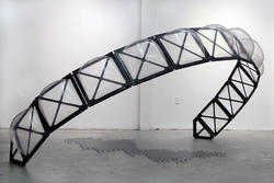 Student work by Jared Akerstrom MFA 2017. A large metallic semicircle covered with bubble shaped glass windows.
