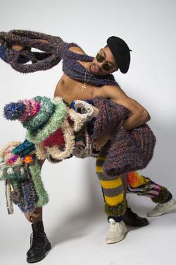 Student work by Lucas Montenegro BFA 2018. Two models engage in dance or combat while wearing unique knitted garments.