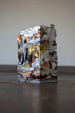 Student sculpture of a multi-colored abstract pressed metal cube 