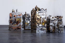 four multi-colored abstract pressed metal cubes