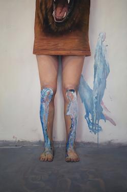 student painting displaying a person standing in front of a wall with blue and white paint on their legs