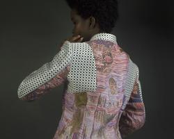 Student work by Talia Connelly BFA 2018. A man models a colorful custom jacket.