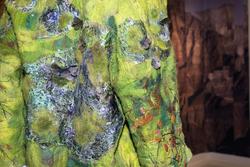 Student work by Yan Zeng MFA 2017. Closeup of a bright green jacket designed with small moths made of fabric.