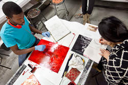 students at a table sketching and applying ink