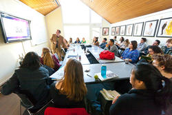 students observing professor's presentation during a liberal arts class