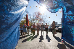 Students are seen through blue tarp gateway.