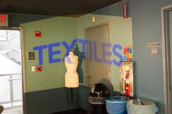 The word Textiles projected in the corner of the textiles room.