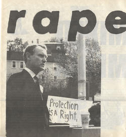 Man standing in front of protest sign