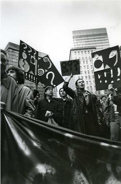 Protestors holding abstract graphic signs