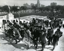 Group of student protesters climbing the Statehouse steps