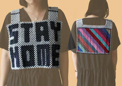 a beaded top that reads STAY HOME on the front, with multicolored lines running diagonally on the back
