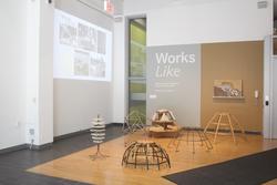 a gallery foyer with a sign on the rear wall for an exhibition titled "Works Like"