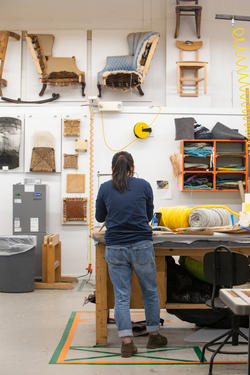 A student works intently at a Furniture Design studio workstation