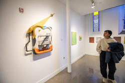 R I S D student walks through a Painting exhibition at Memorial Gallery